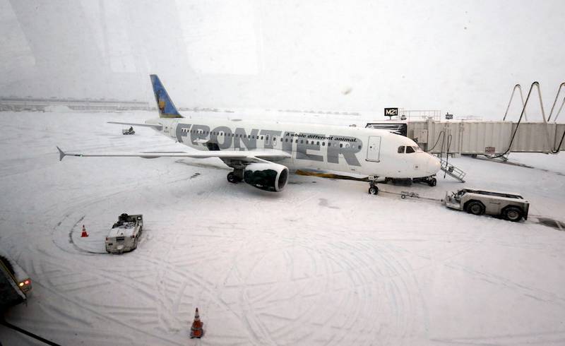 A Frontier airplane waits for passengers at O'Hare International Airport in Chicago, Thursday, Jan. 2, 2014.
