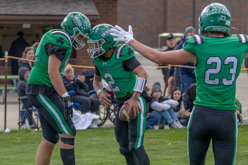 (from left) Zebadiah Maxwell (11) of Seneca butts heads in celebration teammate Gunnar Varland's (2) touchdown on Saturday, November 1, 2025 at Seneca High School in Seneca.