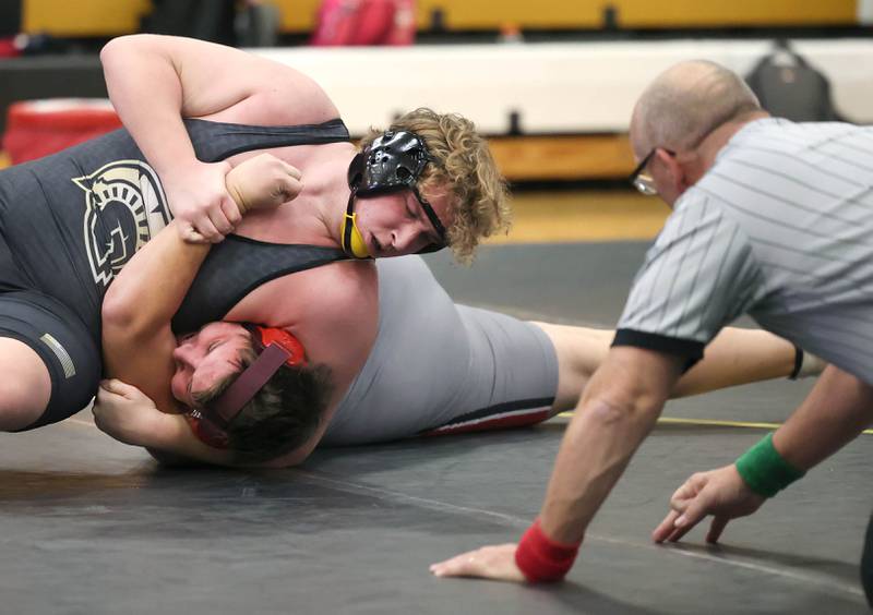 Sycamore’s Asher Dohogne controls Ottawa’s Ethan Day during their 285 pound match Thursday, Dec. 14, 2023, at Sycamore High School.