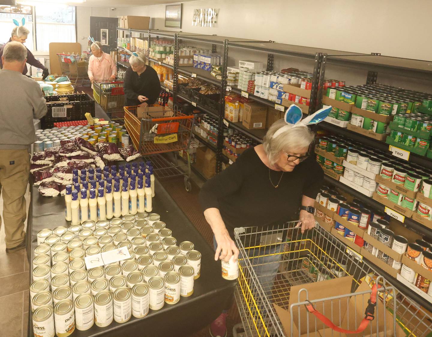 Volunteers fill carts of food during the annual Easter distribution on Wednesday, April 1, 2026 at the Hall Township Food Pantry in Spring Valley.