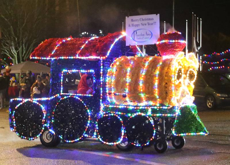 A illuminating train float by the Princeton Area Chamber of Commerce rolls down Main Street in the inaugural Lighted Christmas Parade on Friday, Dec. 1, 2023 in Princeton.