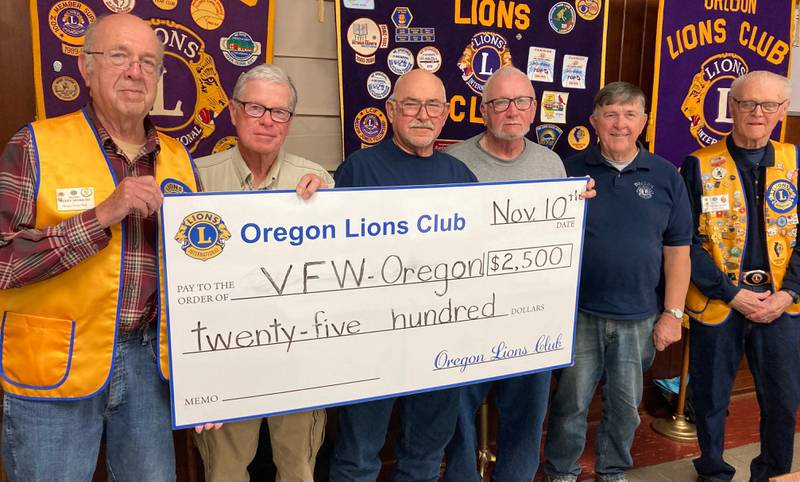 (Left to right); Oregon Lion Jerry Hinrichs, Lion Jim Hoff, VFW member Bob Coulter, Lion Ed Smola, Lion Duane Moser, and Lion Chuck McCourt donating a check to the Oregon VFW