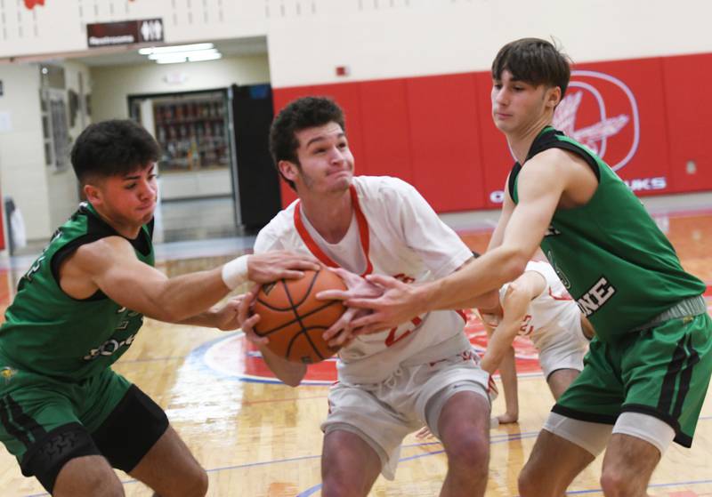 Oregon's Miley Smith drives the lane as two North Boone defenders grab the ball during Saturday, Nov. 26 action at the Oregon Thanksgiving Tournament on Nov. 26.