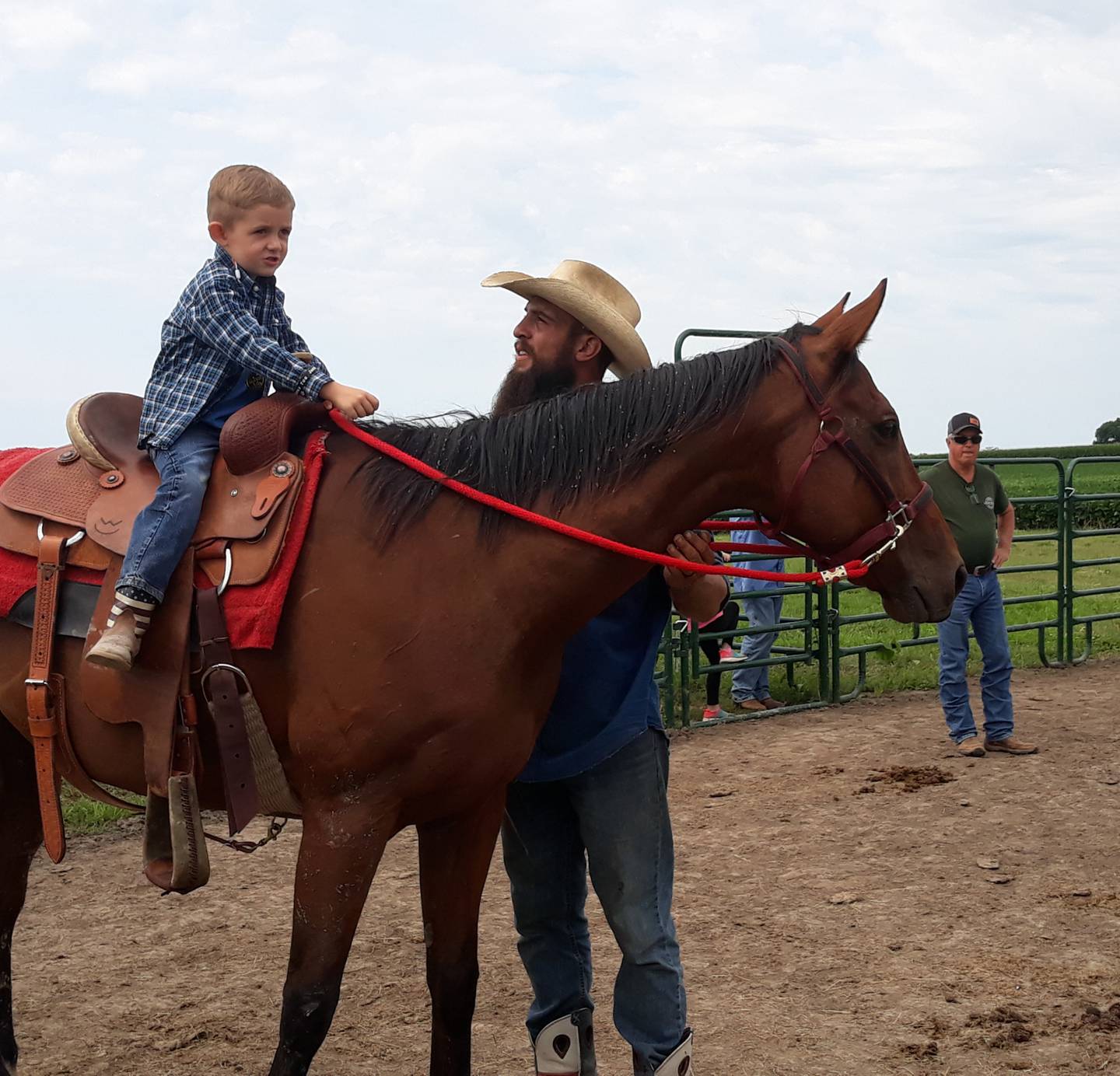 Bill Kehoe's son, Tucker, rides a horse led by missionary from the Leon River Cowboy Church in Eastland, Texas, on Thursday, July 25, 2022, at the Arena of Hope in rural Cornell.