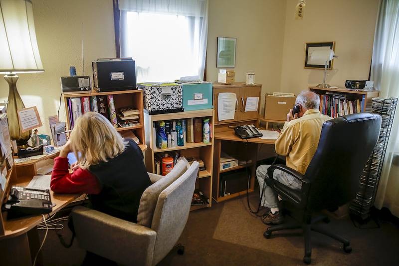 Volunteers staff the crisis hotline call center last week at The Upper Room in Joliet.