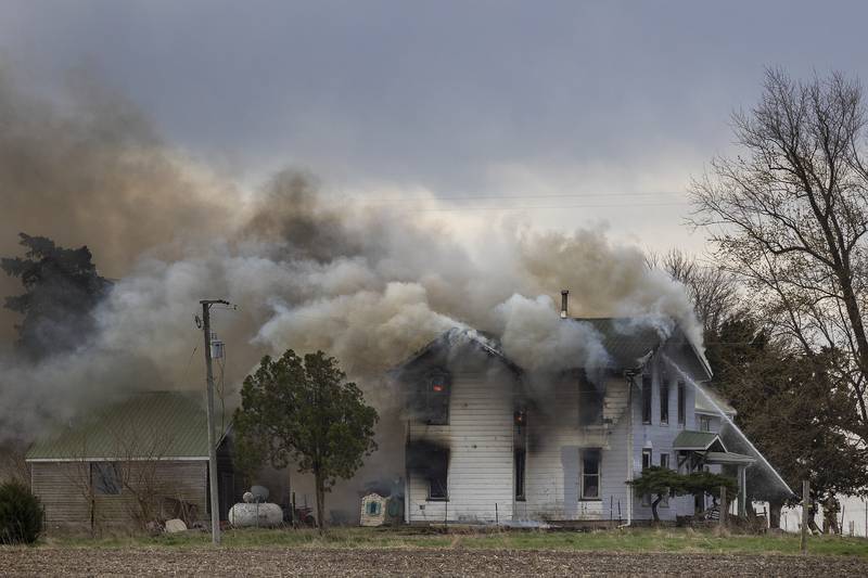 Firefighters battle a house fire Monday, April 14, 2025, at 1308 Harmon Road.