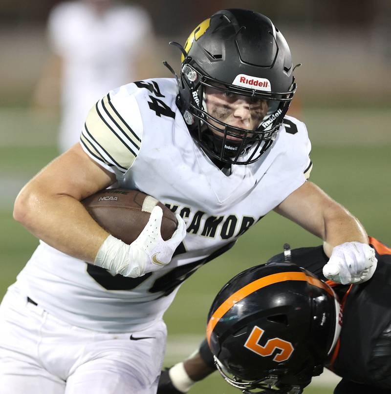 Sycamore's Joey Puleo gets past DeKalb's LaBrian Carrington during the First National Challenge Friday, Aug. 26, 2022, in Huskie Stadium at Northern Illinois University in DeKalb.
