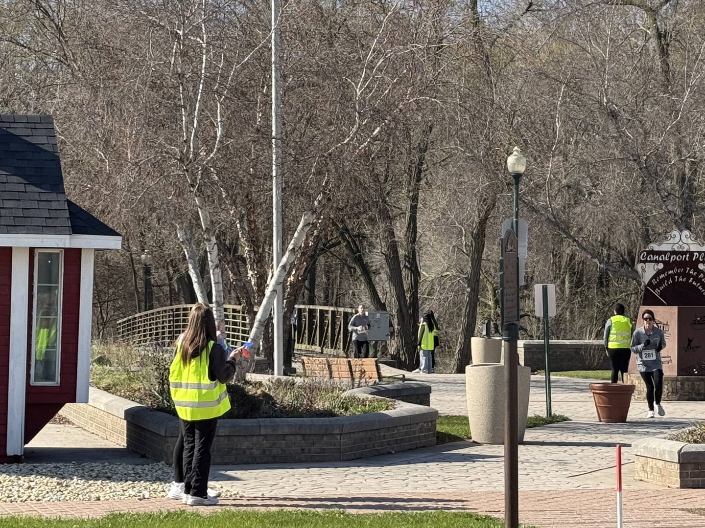 Morris Women's Club Superhero 5K participants race across the bridge crossing the I&M Canal on Saturday, April 12, 2025.