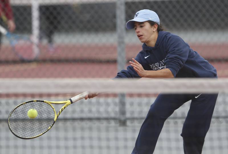 Nazareth Academy’s Diana Anos returns the ball Thursday, Oct. 20, 2022, during during the first day of the IHSA State Girls Tennis Tournament at Schaumburg High School in Schaumburg.