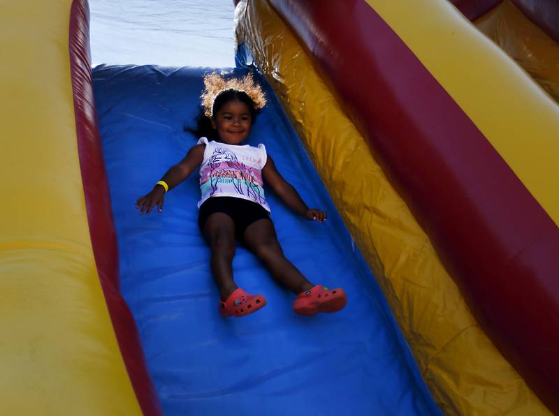 Caylie Crenshaw, 3, of Algonquin, goes down a slide during the Algonquin Founders’ Days Festival Friday, July 29, 2022, at Ted Spella Community Park, 2610 Harnish Drive, in Algonquin. This year marks the festival’s 60th anniversary that includes over 40 events, including live music, food and drinks, a carnival, and market bazaar. The festival runs from 2 to 11 p.m. July 30 and 10 a.m. to 9 p.m. July 31. A Founders’ Day Christmas in July Parade will run through Main Street in downtown Algonquin beginning at 11 a.m. July 30.
