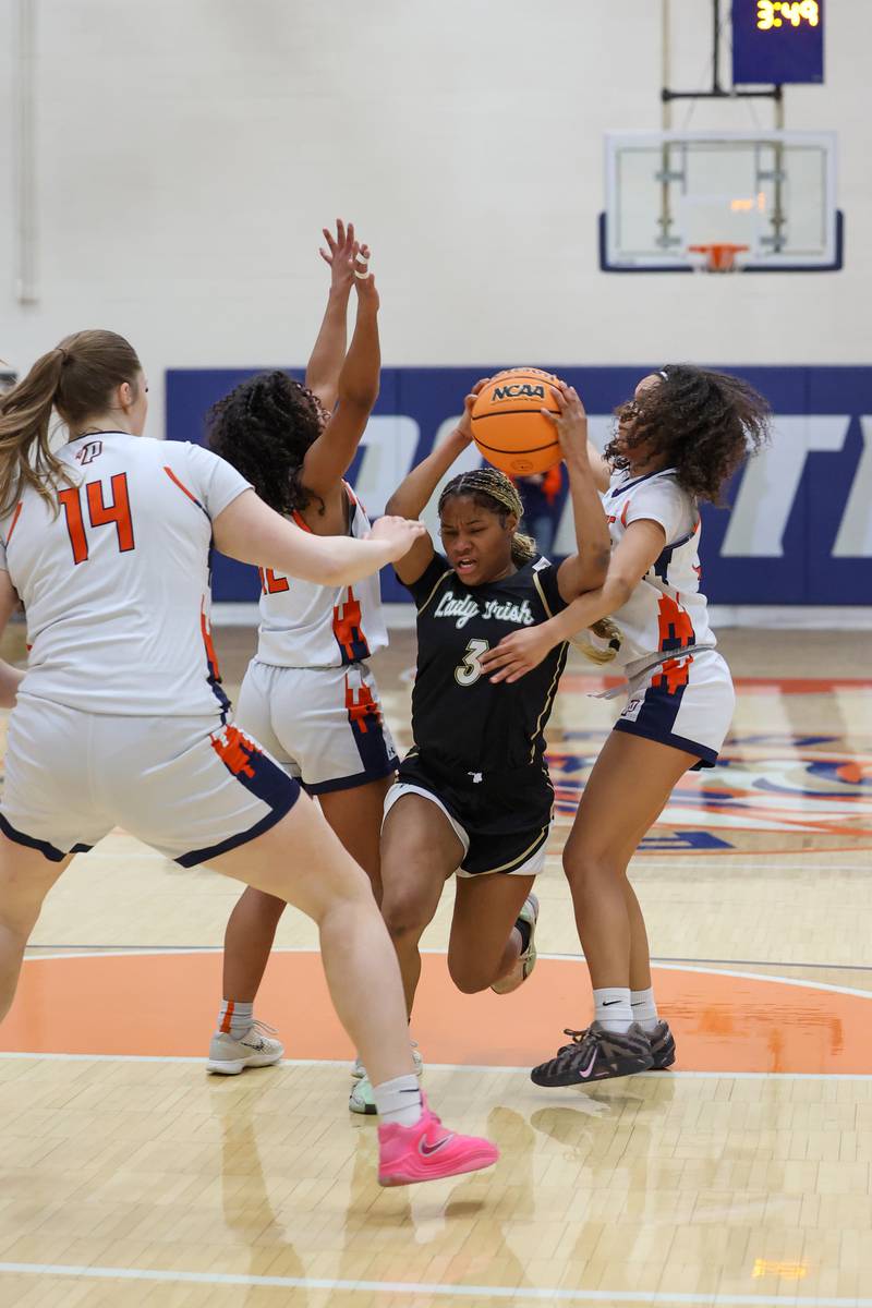 Bishop McNamara’s Eliana Isom maneuvers through defenders during the Fightin’ Irish’s 46-32 loss to Pontiac in the IHSA Class 2A Pontiac Sectional semifinal on Tuesday, Feb. 24, 2026, at Pontiac Township High School.