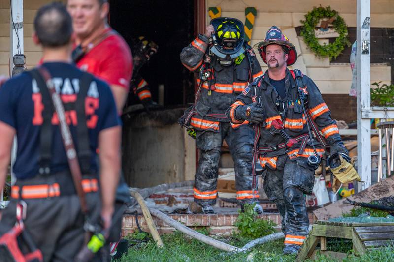 Firefighters walk out of a structure fire on Saturday, July 19, 2025, at the 1400 Block of U.S. Route 6 outside Ottawa.
