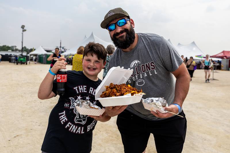 Lockport residents Rocco and Kevin Meisenbach grab some grub during Old Canal Days in Lockport on June, 7, 2025.