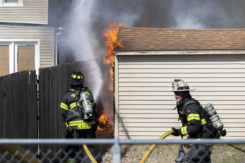 Dixon firefighters hit flames with water Friday, March 14, 2025. Dixon City and Rural responded to a shed fire at 1832 W. First Street.