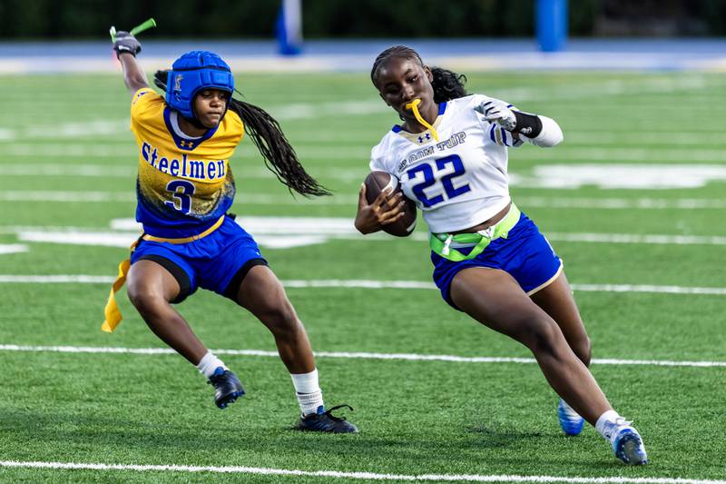 Joliet Central's Ta'Tyanna Nicks tackles Bloom’s Karson Giles during a varsity flag football game at Joliet Central on Sept. 11, 2025.