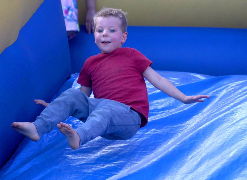 Willem Stroner, 3, of Cary flies down an inflatable slide during the Stars N’ Stripes Fest at Cary-Grove Park in Cary on Saturday, June 28, 2025.