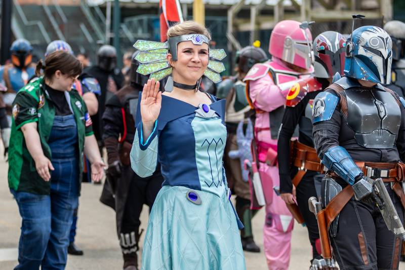 Duchess Satine, portrayed by Amy Caponigro, waves to attendees during Joliet Public Library's Star Wars Day Parade on June 7, 2025.