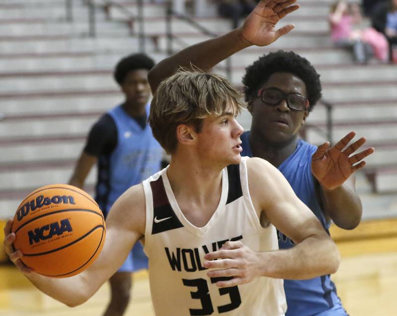 Prairie Ridge's Maddon McKim passes the ball as he pressured by Illinois Math & Science Academy's Lota Onwuameze during a IHSA Class 3A Burlington Central Regional quarterfinal boys basketball game on Monday, feb23, 20256, at Prairie Ridge High School in Crystal Lake.