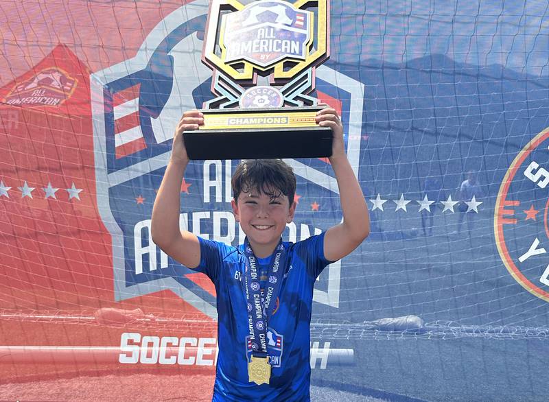 AJ Anderson 10 of Princeton, hoists the championship trophy after winning the U12 All American Youth Soccer tournament on Sunday, July 2, 2023 in Gatlinburg Tenn. Anderson scored three goals in five games and had over a dozen assists. The camp requires kids to be nominated by a coach and have a video submission to attend.