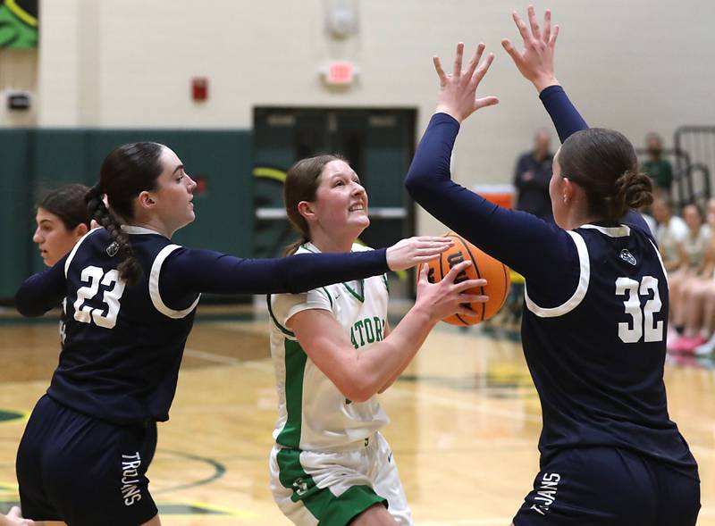 Crystal Lake South's Gaby Dzik (center) drives to the basket between Cary-Grove's Avery Hoffman (left) and Olivia Leuze (right) during a Fox Valley Conference girls basketball game on Friday, Jan. 23, 2026, at Crystal Lake South High School.