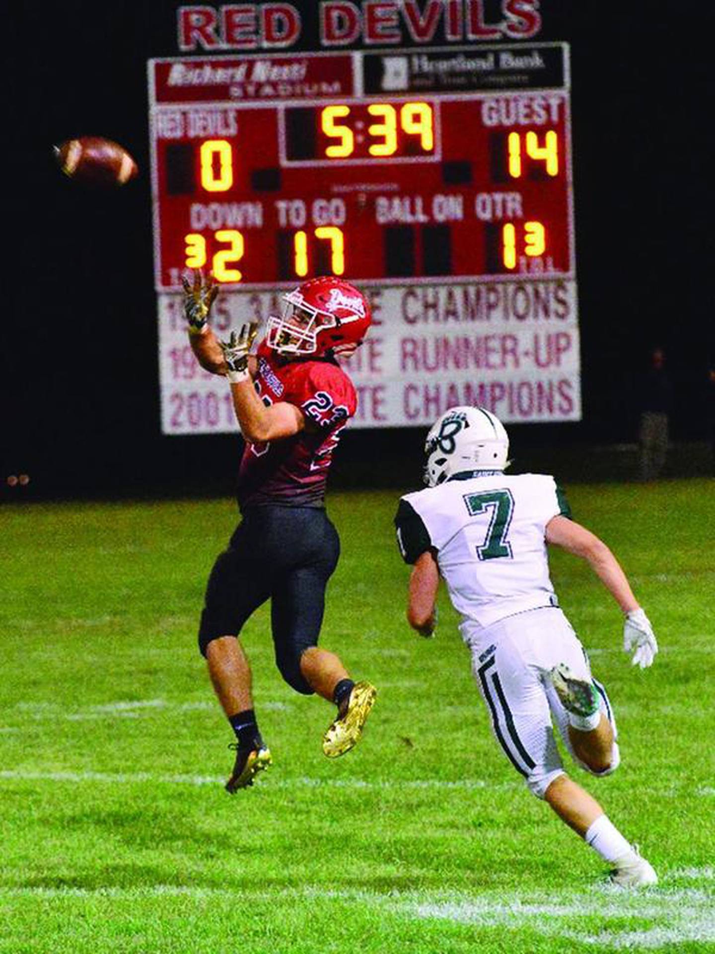 Hall's James Mautino gets ready to catch a pass as St. Bede's Braden Damerell goes in for the tackle in the first half of Friday night's game in Spring Valley.