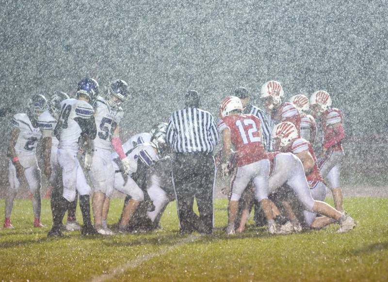 Lutheran takes a knee to run out the clock as heavy rain falls on Landers-Loomis Field on Friday, Oct. 13, 2023.