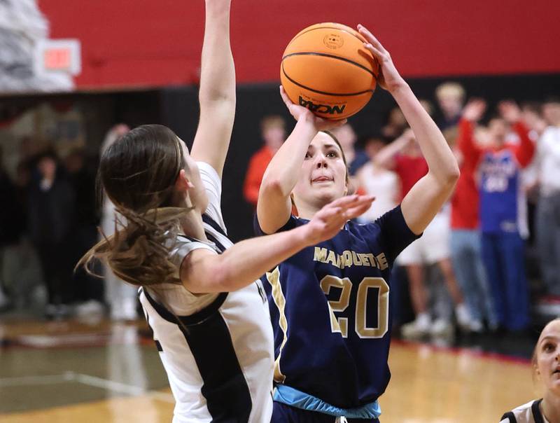 Marquette's Kaitlyn Davis shoots over Rockford Christian's Josie Becker Tuesday, Feb 24, 2026, during their Class 1A sectional semifinal game at Indian Creek High School in Shabbona.