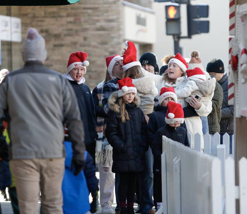 Families wait in line to see Santa Claus at the Gingerbread House in Downers Grove, Ill. on Sunday, Dec. 18, 2022.