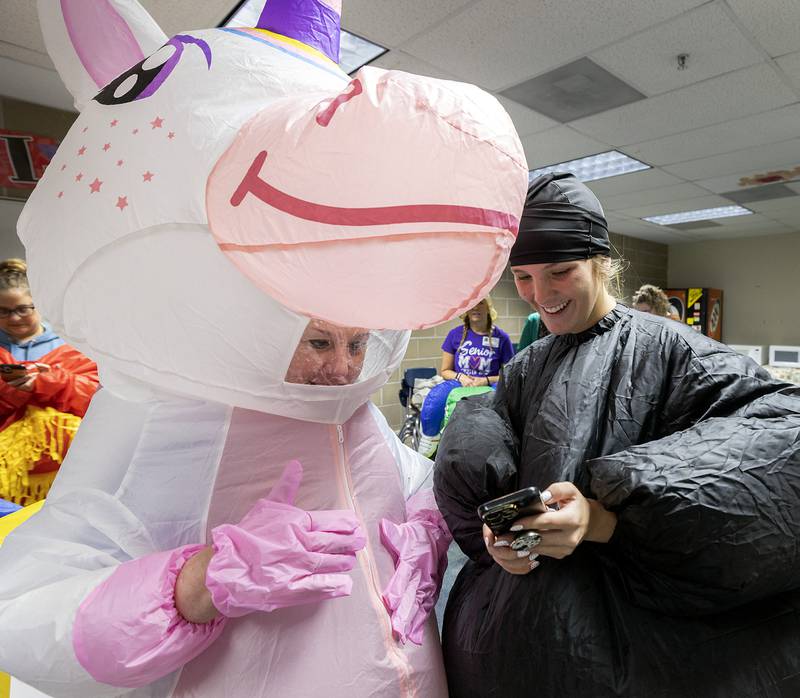 Christy Zepezauer (left) and Jaylee Dugger go over how to post a Tik Tok Wednesday, May 21, 2025, while waiting for their students at Reagan Middle School.