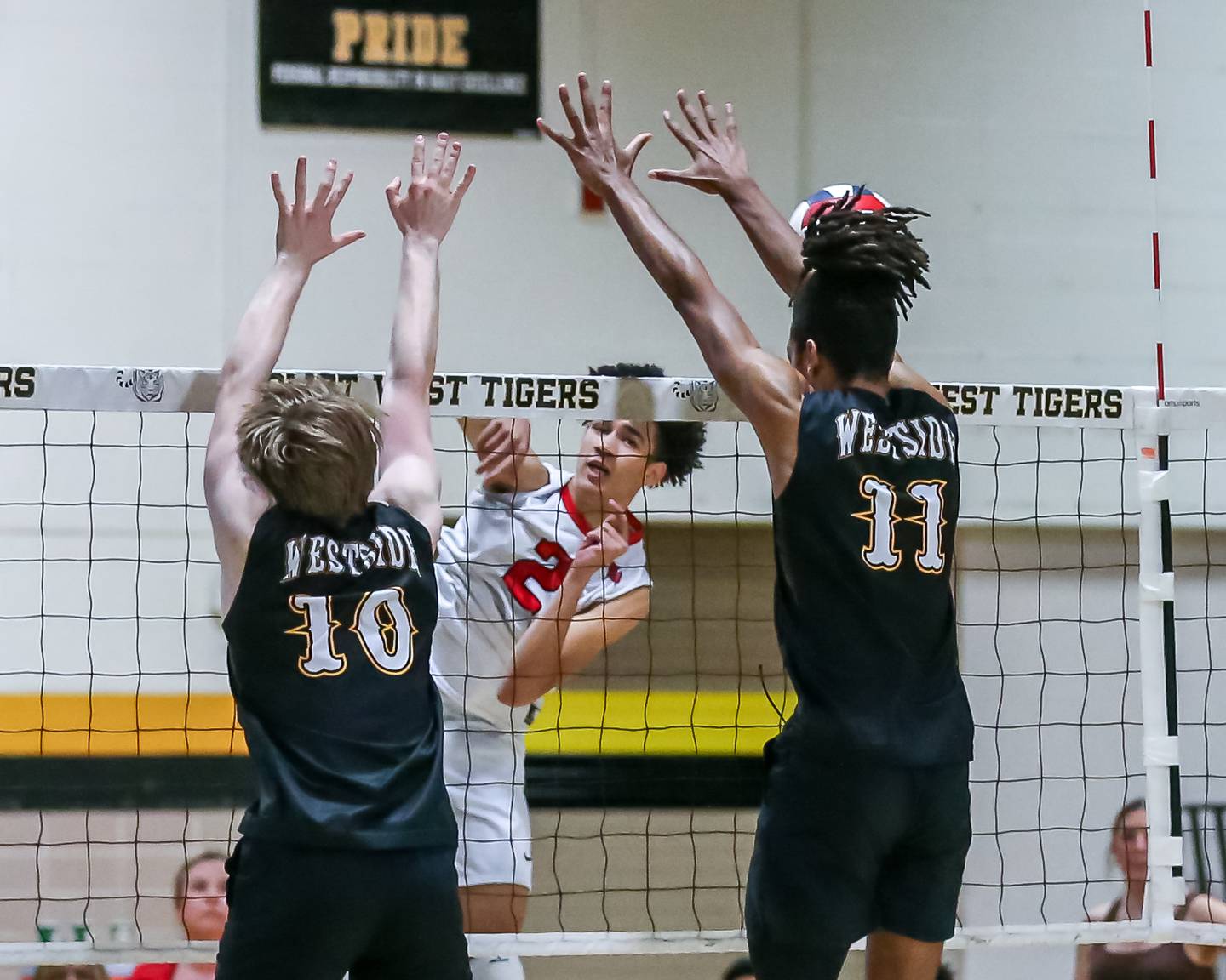 Bolingbrook's Trevor Wardlow (2) smashes the ball over the net during Joliet West Regional Championship match between Bolingbrook at Joliet West.  May 23, 2024.