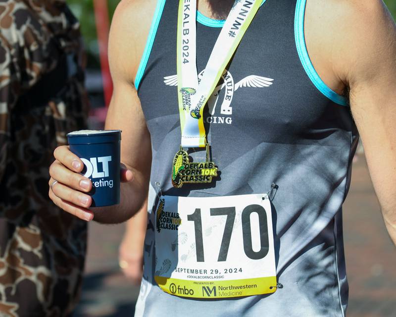 Kenneth Borre enjoys an after-race drink at the Taste of DeKalb after he ran in the DeKalb Corn Classic 10K on Sunday, Sept. 29, 2024. Borre took first in his age group.