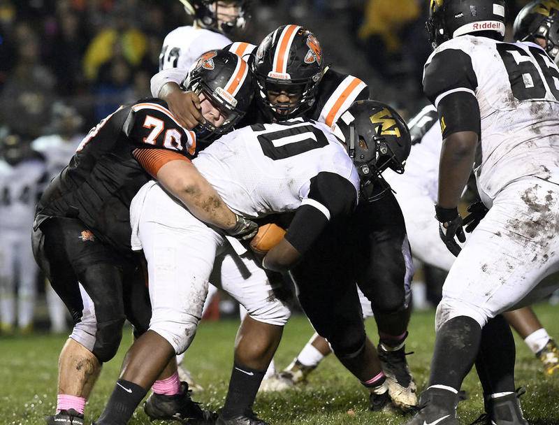 Minooka's defense stops Joliet West’s Kendrick Roach on Friday, Oct. 6, 2017 at Minooka High School in Minooka, Ill. Minooka won, 31-7.