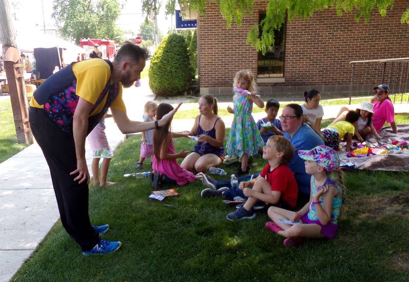 A magician demonstrates a trick Saturday, June 3, 2023, during the Summer Reading Kick-Off Party at Reddick Library in Ottawa.