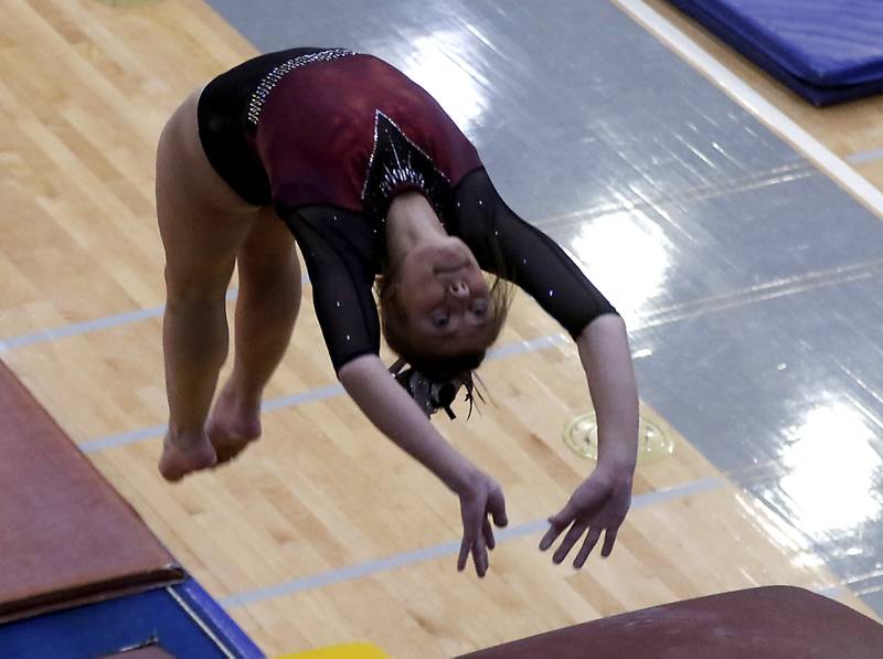 Prairie Ridge's Gabby Riley competes in the preliminary round of the vault Friday, Feb. 17, 2023, during the IHSA Girls State Final Gymnastics Meet at Palatine High School.