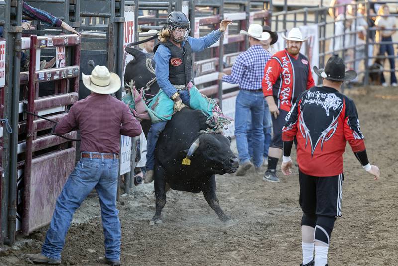 Matthew Weaver holds on for a qualifying ride Tuesday, August 15, 2023 in the Next Level Pro Bull Riding event at the Whiteside County Fair.