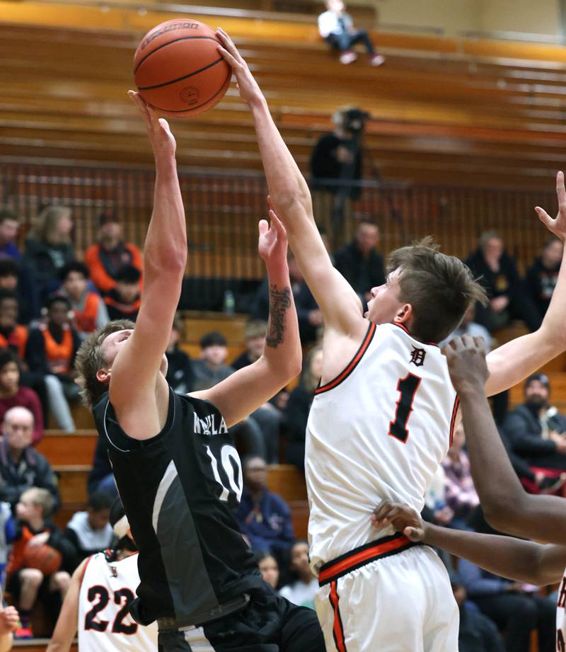 Kaneland's Troyer Carlson has his shot blocked by DeKalb’s Jackson Kees during their game Monday, Feb. 12, 2024, at Huntley Middle School in DeKalb.