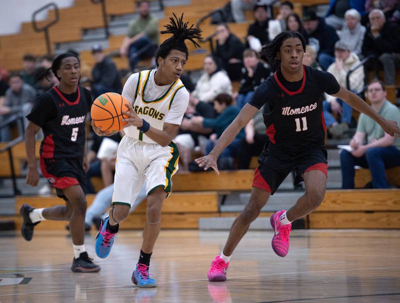 Grant Park's Ka'Shawn Sherrod, center, leads on a break away as Momence's Aiden Smith, left, and D'Angelo Hundley, right, follow in a game on Friday, January 16, 2026.