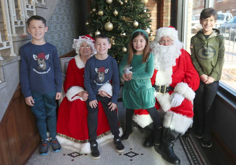 (From left) Theo Johnson and his brother Vinny of Tonica, along with Amaria Goskusky and her brother Colton pose with Santa and Mrs. Claus at the Auditorium Ballroom on Saturday, Dec. 7, 2024 downtown La Salle. The event is part of the Miracle on First Street celebration.