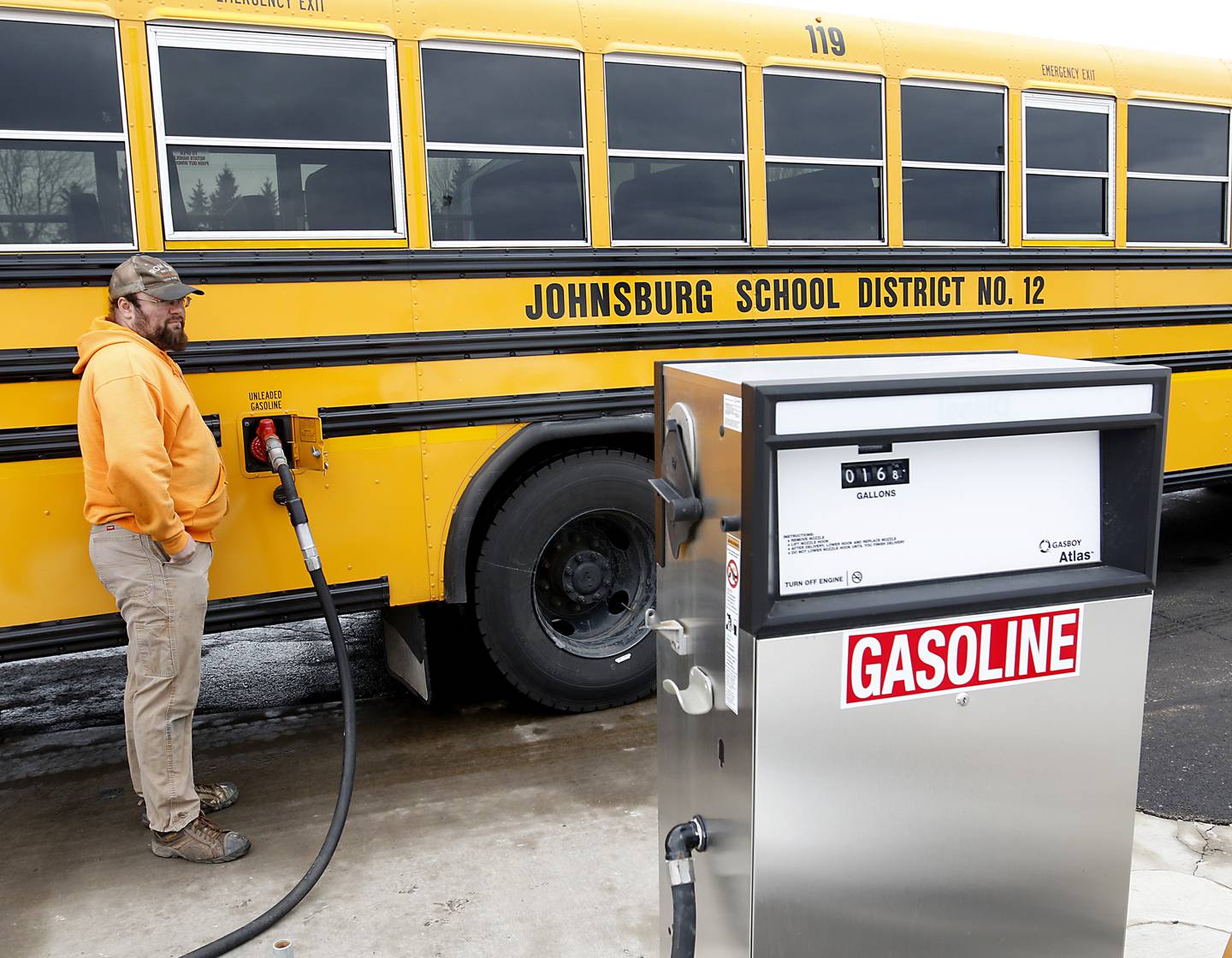Bus driver and mechanic Jim Schmidt fills one of Johnsburg School District 12's new school buses with gas on Wednesday, Feb. 16, 2022. Before Johnsburg School District 12 stabilized its finances, the district could not afford to lease a brand-new fleet of school buses. These buses, which are 2022 models, were ordered over the summer and arrived in August. Getting to lease new meant that the district had more control of what direction it wanted to go, Director of Operations Tom Schwarz said, and so it decided to go with gasoline over diesel, which he said is better in terms of reliability and maintenance. That's one way the initial outlay may actually save the district money in the long term, he said. The district was also able to afford a longer five-year lease, which has a lower per-year cost. He said the district has also seen fewer behavioral issues with students vandalizing the buses now that they're nice and new.