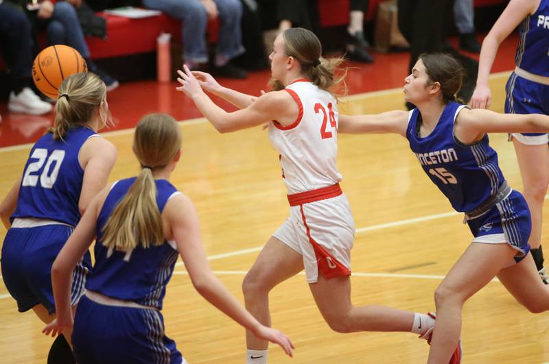 Ottawa's Ashlynn Ganiere looks to pass the ball around Princeton's Reese Reviglio and Payton Brandt on Monday, Feb. 3, 2025 in Kingman Gymnasium at Ottawa High School.