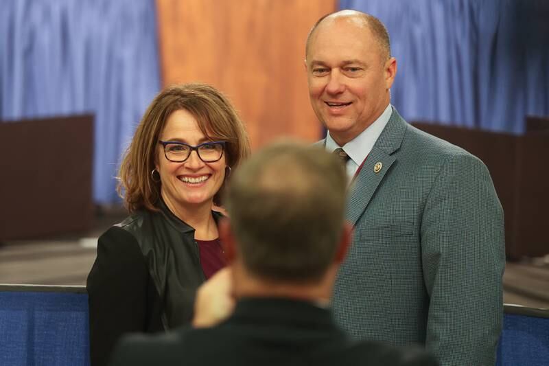 Senator Meg Loughran Cappel, left, and Senator Eric Mattson poses for a photo before President Joe Biden takes the stage during his stop in Joliet at Jones Elementary School on Saturday.