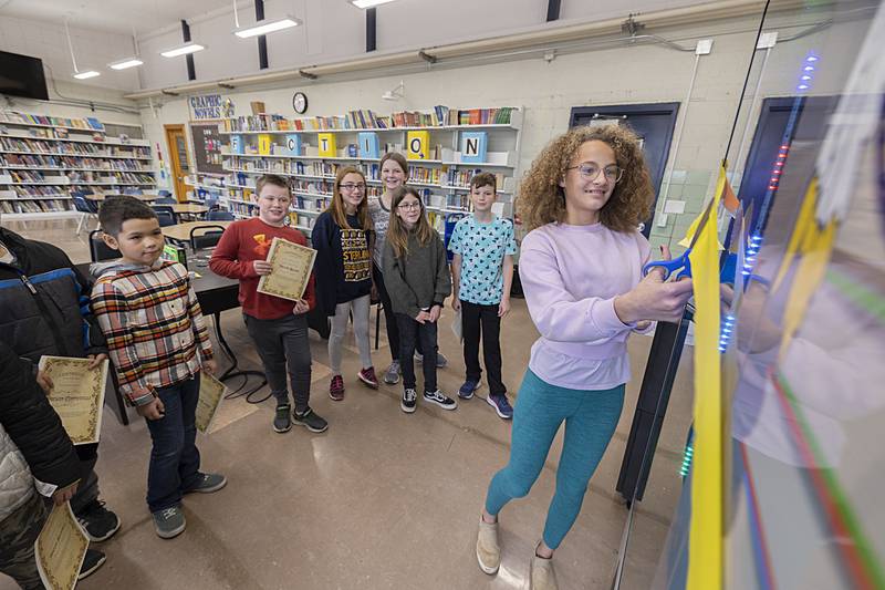 Sterling Washington School student Ava Rodriquez cuts the ribbon officially opening the school’s new book vending machine. Packed with books of all reading levels, the flashy machine talks and has LED lights in an effort to increase pleasure reading for the students.