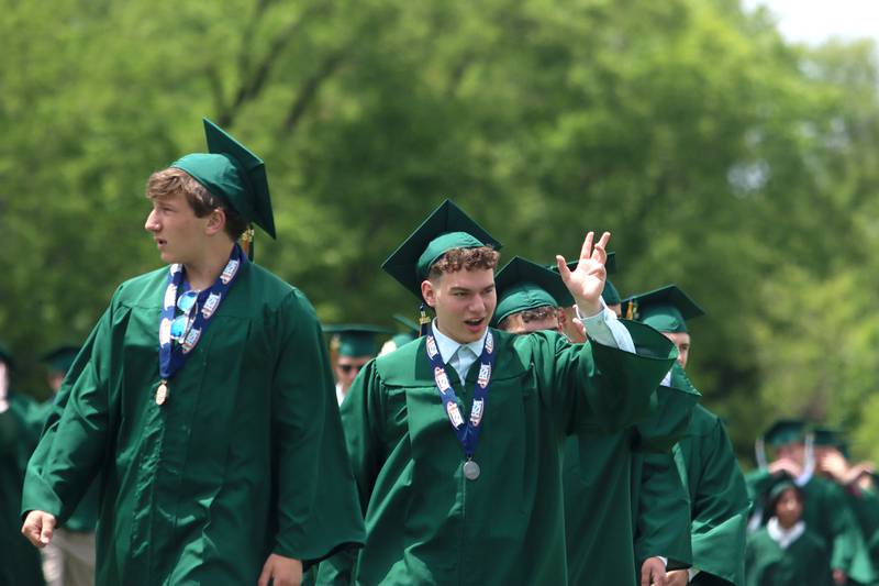 Members of the Class of 2025 march into the stadium for graduation at York High School in Elmhurst on Sunday, May 18, 2025.