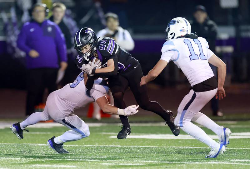Prospect's Will Fidler (8) Benjamin Galbreath (11) contain Downers Grove North's Grant Georgas (40) during the IHSA Class 7A playoff football game Friday, Oct. 31, 2025 in Downers Grove.