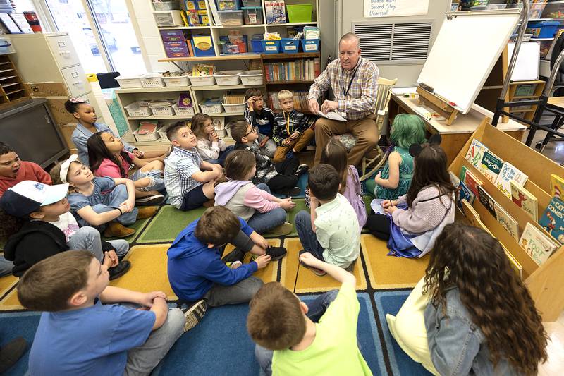 Brian Lobdell, a second grade teacher at Franklin Elementary School in Sterling, starts the day with a song and meeting with his students Thursday, March 27, 2025. The meeting lets the students know what they’ll be working on for the day.