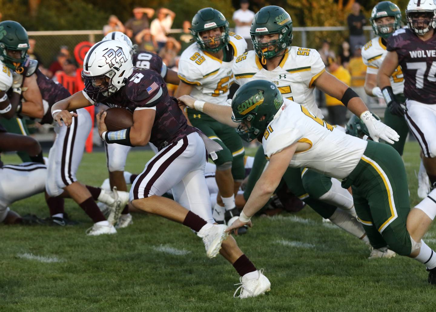 Prairie Ridge’s Joseph Vanderwell runs away from Crystal Lake South's Dominic Ariola during a Fox Valley Conference football game Friday, Sept. 1, 2023, at Prairie Ridge High School inCrystal Lake.