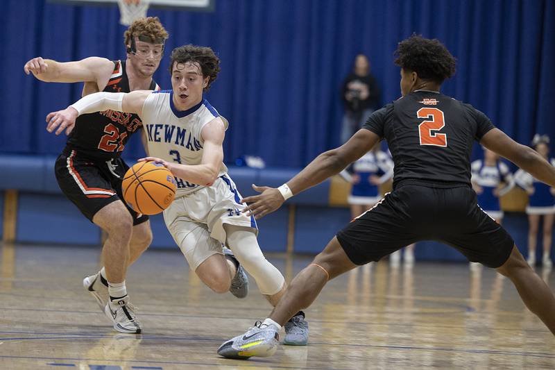 Newman’s Garret Matznick splits a pair of Milledgeville defenders Monday, Feb. 24, 2025, during a Class 1A Regional quarterfinal at Newman High School.