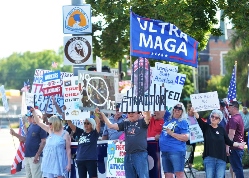 Demonstrators both for and against President Donald Trump and his policies hold signs and flags at the "Workers Over Billionaires" rally in downtown Oregon on Monday, Sept. 1, 2025.