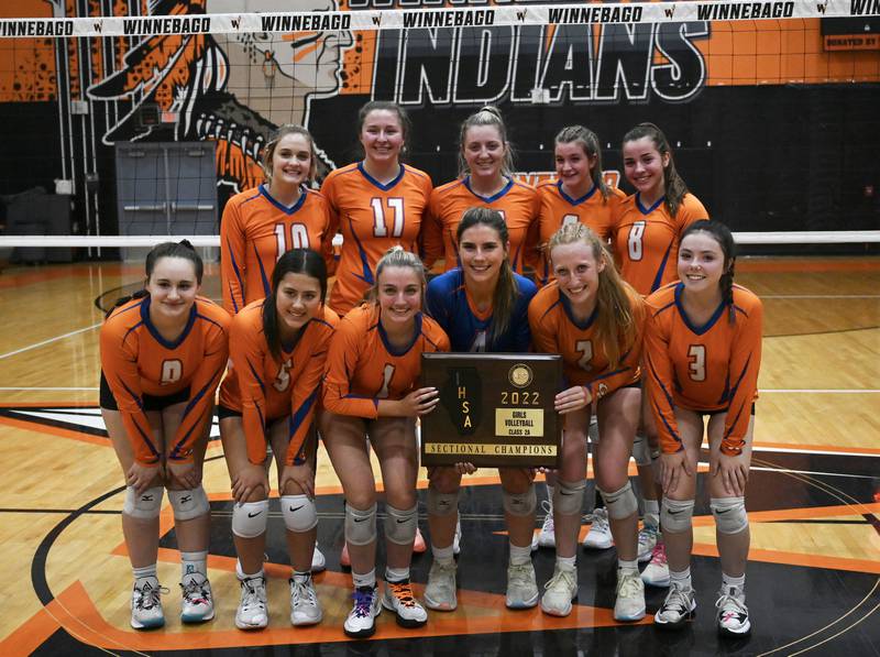 Genoa-Kingston poses with their 2A sectional title after their win over Rock Falls in 2 sets, 25-11, 25-23. The Cogs will play Quincy Notre Dame on Friday in Princeton.