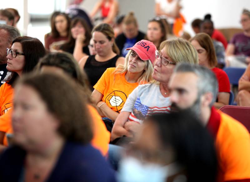 A contingency of parents, teachers and community members against a mask requirement wore orange shirts voicing their opinion during a St. Charles School District 303 School Board Learning and Teaching Committee meeting at the Haines Center in St. Charles on Monday, July 19, 2021. The board heard public comment regarding the district's COVID-19 protocols for the new school year, especially the issue of students wearing masks during school.